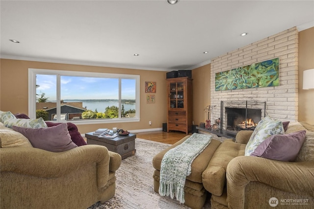 245 SW 298th Pl, Federal Way, WA 98023 - living area featuring a brick fireplace, crown molding, wood finished floors, recessed lighting, and a water view