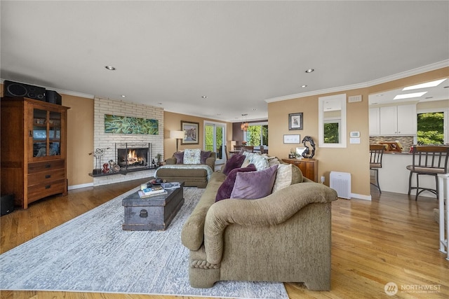 245 SW 298th Pl, Federal Way, WA 98023 - living area featuring light wood-style floors, a fireplace, recessed lighting, ornamental molding, and baseboards
