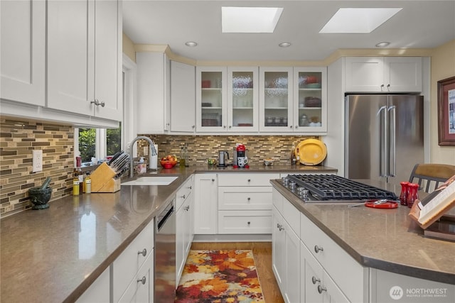 245 SW 298th Pl, Federal Way, WA 98023 - kitchen featuring stainless steel appliances, a sink, a skylight, white cabinetry, and recessed lighting