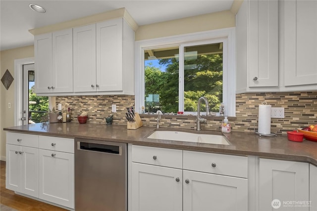 245 SW 298th Pl, Federal Way, WA 98023 - kitchen featuring dishwasher, a sink, dark countertops, and decorative backsplash