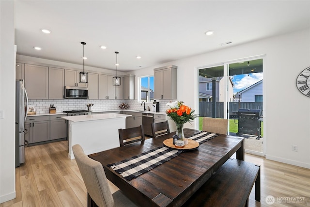 12605 179th St E, Puyallup, WA 98374 - dining room with light wood-style flooring, recessed lighting, and baseboards