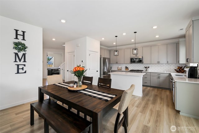 12605 179th St E, Puyallup, WA 98374 - dining area featuring light wood finished floors, recessed lighting, and baseboards
