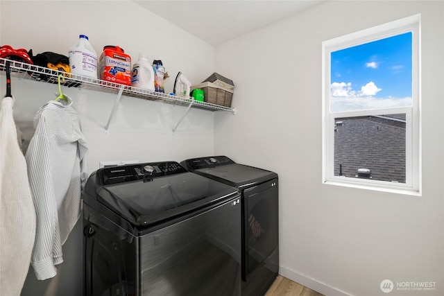 12605 179th St E, Puyallup, WA 98374 - laundry room with washer and dryer, light wood-style floors, and baseboards