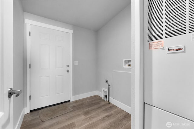 2076 Crystal Mountain Dr Unit 89, Enumclaw, WA 98022 - laundry area with a heating unit, hookup for a washing machine, wood finished floors, baseboards, and electric dryer hookup