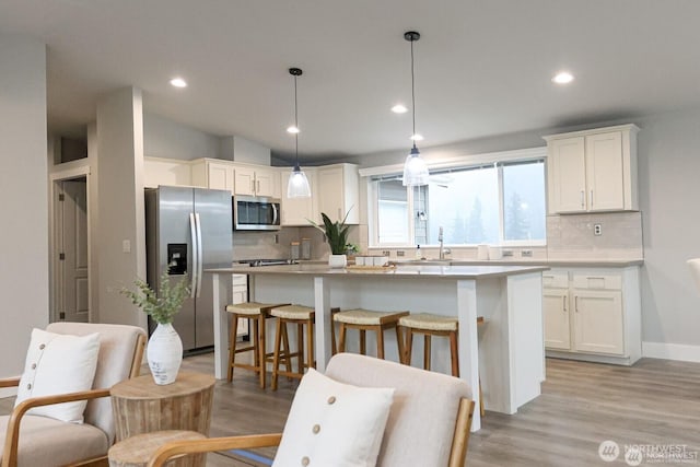 2076 Crystal Mountain Dr Unit 89, Enumclaw, WA 98022 - kitchen with stainless steel appliances, backsplash, a center island, white cabinets, and recessed lighting