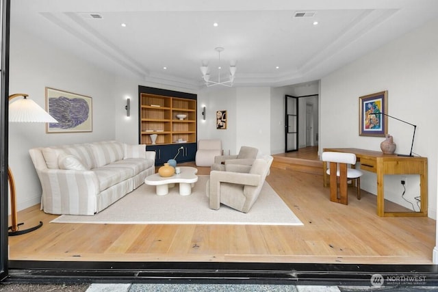 3727 W Barrett St, Seattle, WA 98199 - living area featuring wood finished floors, a raised ceiling, built in shelves, baseboards, and recessed lighting