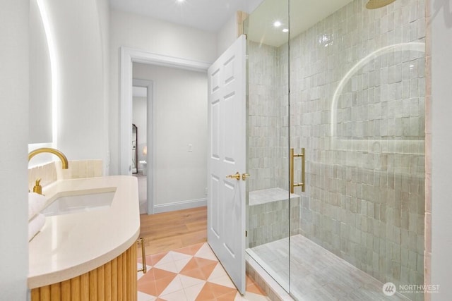 3727 W Barrett St, Seattle, WA 98199 - bathroom with a stall shower, vanity, wood finished floors, recessed lighting, and baseboards