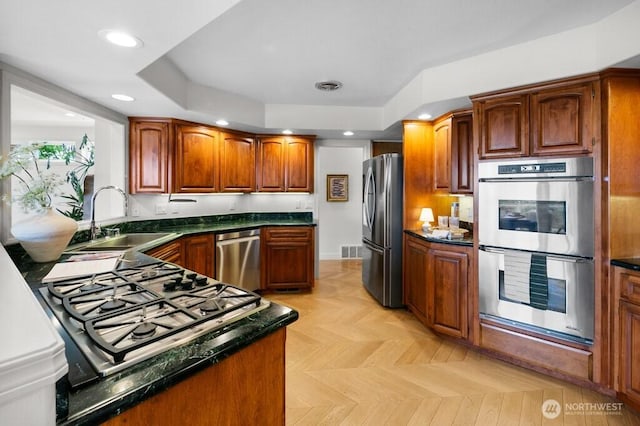 3727 W Barrett St, Seattle, WA 98199 - kitchen with appliances with stainless steel finishes, a sink, recessed lighting, and brown cabinets