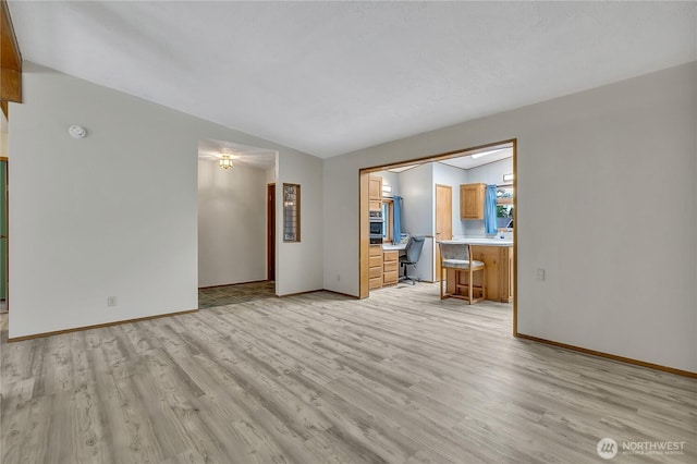 11120 SE 234th Pl, Kent, WA 98031 - unfurnished living room featuring light wood-style flooring and baseboards