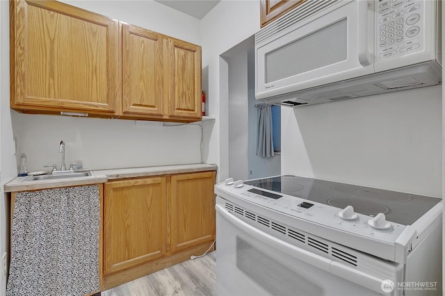 11120 SE 234th Pl, Kent, WA 98031 - kitchen featuring white appliances, a sink, light countertops, and light wood finished floors