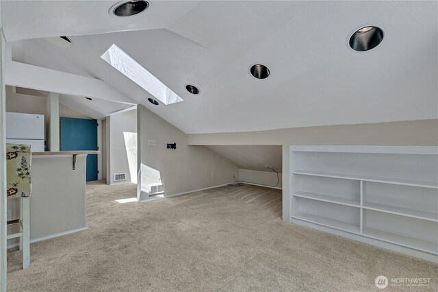 11120 SE 234th Pl, Kent, WA 98031 - additional living space featuring lofted ceiling, light carpet, a skylight, built in features, and baseboards