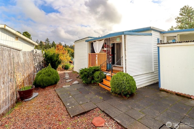 view of outbuilding featuring fence