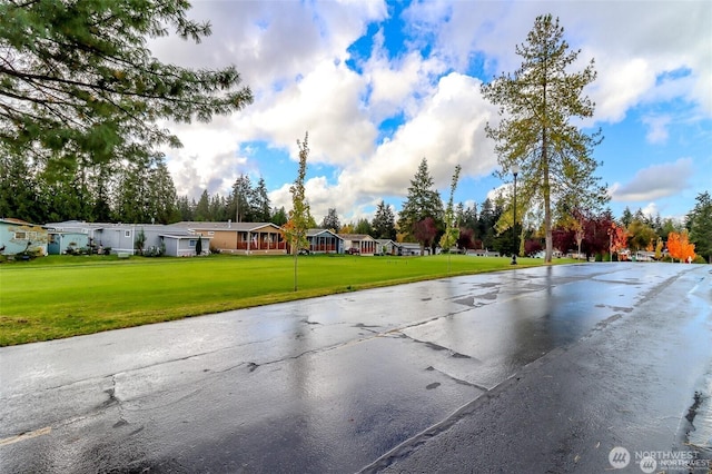 view of asphalt street featuring a residential view
