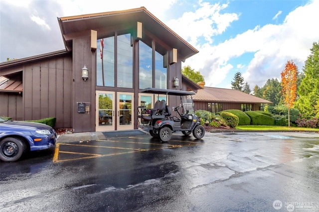 view of building exterior with uncovered parking
