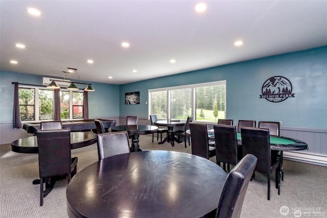 carpeted dining space featuring wainscoting and recessed lighting