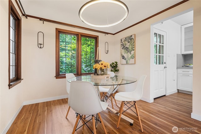 6026 35th Ave NE, Seattle, WA 98115 - dining area with light wood-type flooring, baseboards, and ornamental molding
