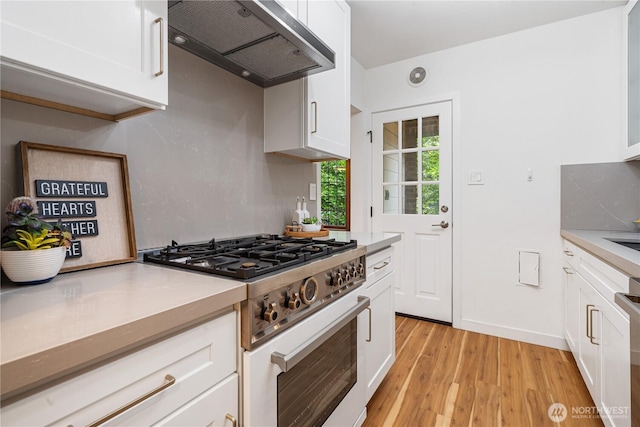 6026 35th Ave NE, Seattle, WA 98115 - kitchen featuring gas range oven, extractor fan, light wood finished floors, and light countertops