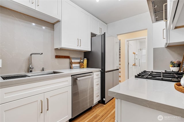 6026 35th Ave NE, Seattle, WA 98115 - kitchen featuring stainless steel dishwasher, a sink, light countertops, and white cabinets