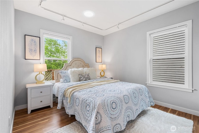 6026 35th Ave NE, Seattle, WA 98115 - bedroom featuring track lighting, wood finished floors, and baseboards