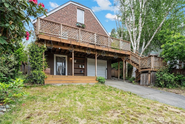 6026 35th Ave NE, Seattle, WA 98115 - back of property with a wooden deck, asphalt driveway, a garage, and a lawn