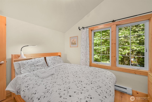 7117 Rainier Way, Deming, WA 98244 - bedroom with baseboard heating, lofted ceiling, and wood finished floors
