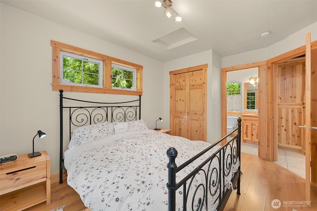 7117 Rainier Way, Deming, WA 98244 - bedroom with light wood-type flooring, track lighting, and connected bathroom