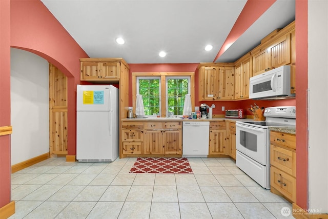 7117 Rainier Way, Deming, WA 98244 - kitchen with white appliances, light tile patterned floors, light countertops, arched walkways, and vaulted ceiling