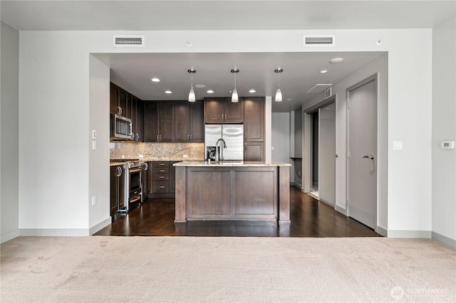 kitchen featuring stainless steel appliances, dark brown cabinetry, baseboards, dark carpet, and recessed lighting