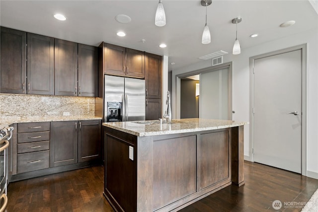 kitchen featuring stainless steel fridge with ice dispenser, a sink, dark wood-type flooring, hanging light fixtures, and recessed lighting