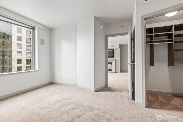 unfurnished bedroom featuring carpet floors, a closet, and baseboards