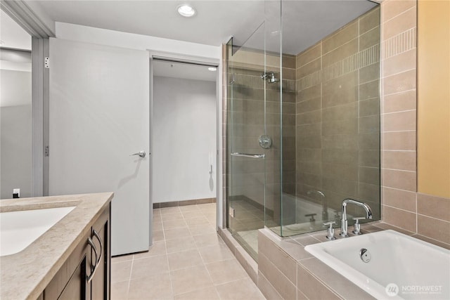 bathroom featuring a shower stall, tile patterned flooring, a bath, recessed lighting, and vanity