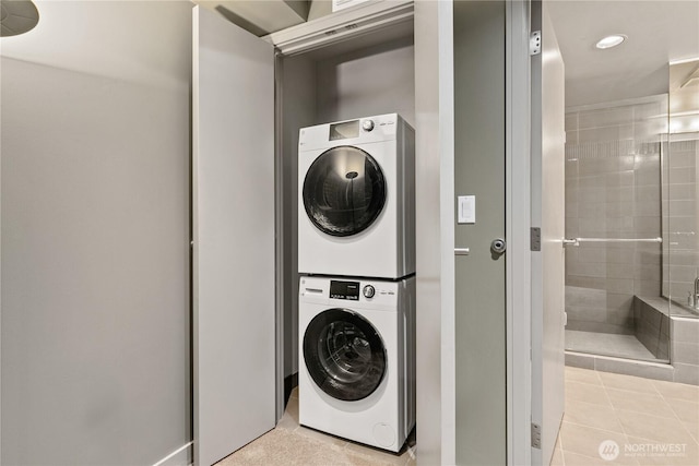 washroom featuring stacked washer and clothes dryer, recessed lighting, and light tile patterned floors