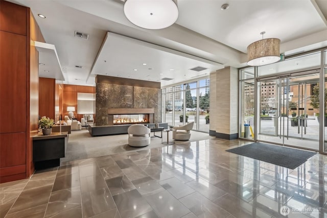 community lobby with expansive windows and recessed lighting