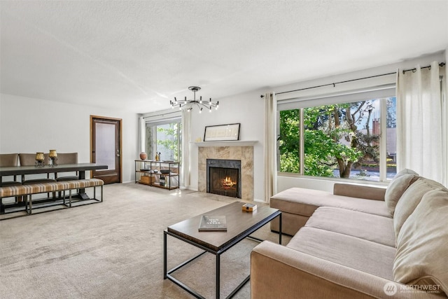 132 N 132nd Unit 202, Seattle, WA 98133 - carpeted living room featuring a chandelier, a high end fireplace, and a textured ceiling