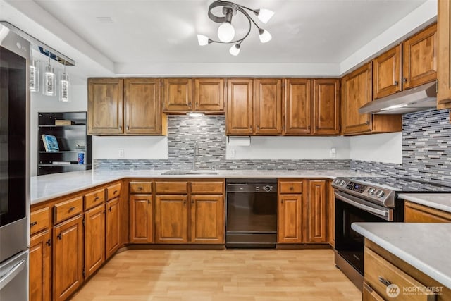 132 N 132nd Unit 202, Seattle, WA 98133 - kitchen with black dishwasher, under cabinet range hood, stainless steel electric range oven, brown cabinetry, and light wood-type flooring