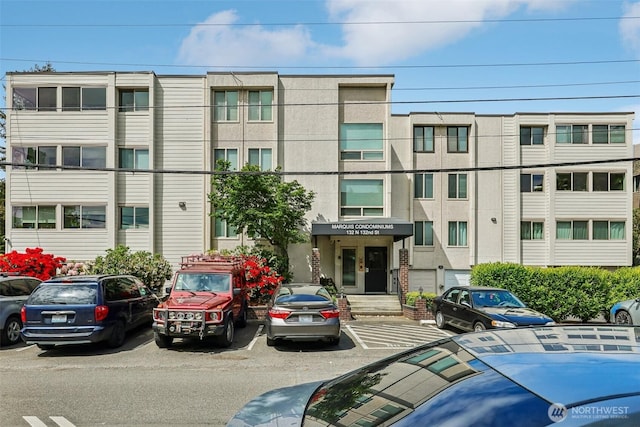 132 N 132nd Unit 202, Seattle, WA 98133 - view of building exterior featuring uncovered parking