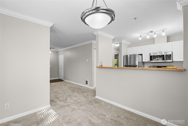 33020 10th Ave SW Unit Y304, Federal Way, WA 98023 - kitchen with stainless steel appliances, light carpet, ornamental molding, baseboards, and white cabinetry