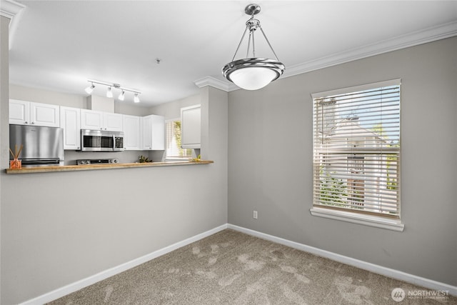 33020 10th Ave SW Unit Y304, Federal Way, WA 98023 - kitchen with appliances with stainless steel finishes, carpet floors, baseboards, white cabinets, and pendant lighting