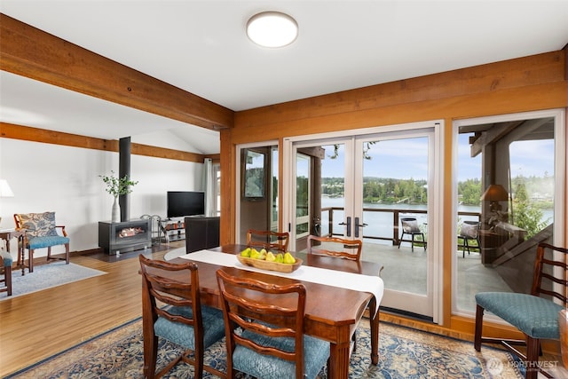 131 N Bay Ln Unit 4, Port Ludlow, WA 98365 - dining room featuring a wood stove, healthy amount of natural light, french doors, and wood finished floors