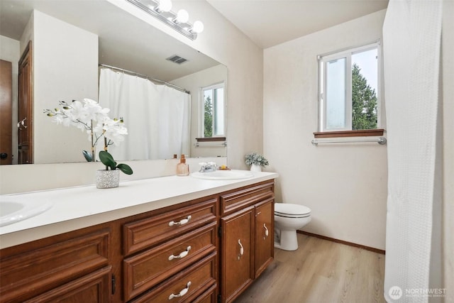3512 Frances Dr SE, Lacey, WA 98503 - bathroom with double vanity, wood finished floors, toilet, and baseboards