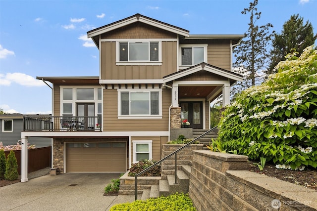 2512 Taylor Dr, Everett, WA 98203 - view of front of home featuring board and batten siding, driveway, stone siding, an attached garage, and stairs