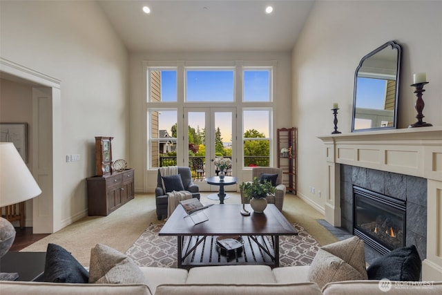 2512 Taylor Dr, Everett, WA 98203 - living room with high vaulted ceiling, a tiled fireplace, light colored carpet, plenty of natural light, and recessed lighting