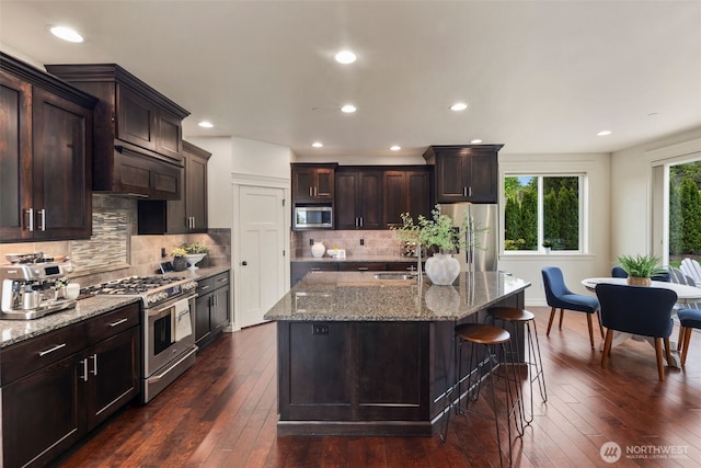 2512 Taylor Dr, Everett, WA 98203 - kitchen with stainless steel appliances, light stone counters, dark wood finished floors, backsplash, and recessed lighting