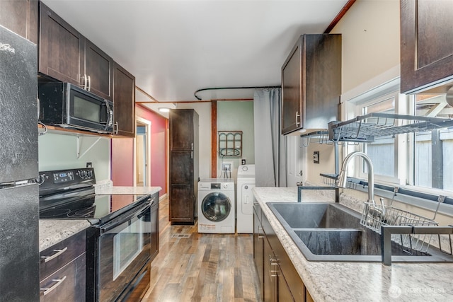 7311 Chambers Creek Rd W Unit 37, University Place, WA 98467 - kitchen featuring black appliances, light wood finished floors, washer and clothes dryer, dark brown cabinetry, and a sink