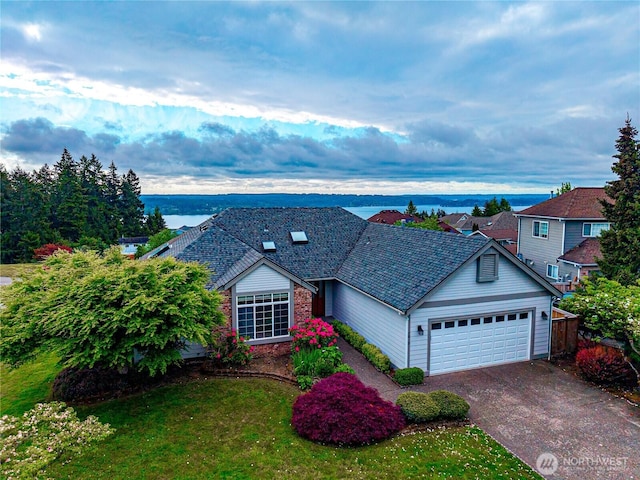 7819 Amethyst Loop NW, Silverdale, WA 98383 - view of front of house with a garage, concrete driveway, and a water view