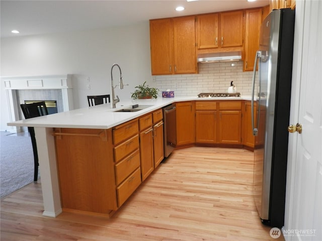 7819 Amethyst Loop NW, Silverdale, WA 98383 - kitchen featuring appliances with stainless steel finishes, a sink, light wood-style floors, recessed lighting, and decorative backsplash