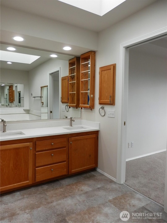 7819 Amethyst Loop NW, Silverdale, WA 98383 - full bath with double vanity, recessed lighting, a skylight, and baseboards