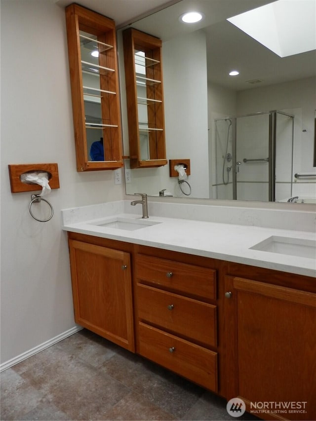7819 Amethyst Loop NW, Silverdale, WA 98383 - bathroom featuring a skylight, a stall shower, double vanity, baseboards, and recessed lighting