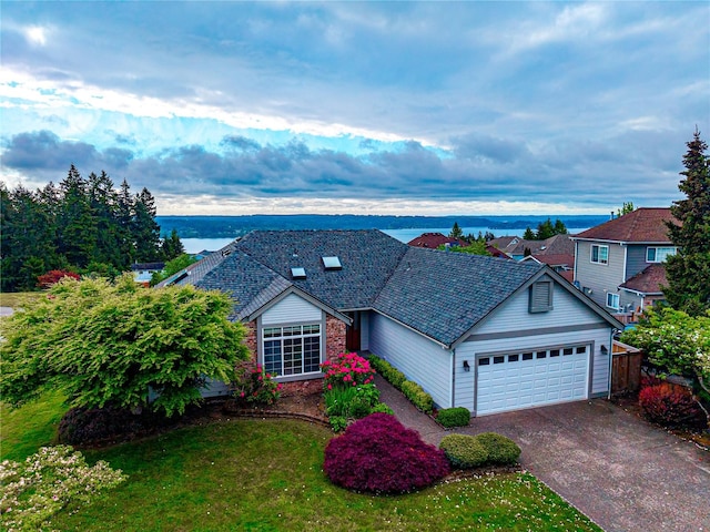7819 Amethyst Loop NW, Silverdale, WA 98383 - view of front of house with an attached garage, concrete driveway, and a water view