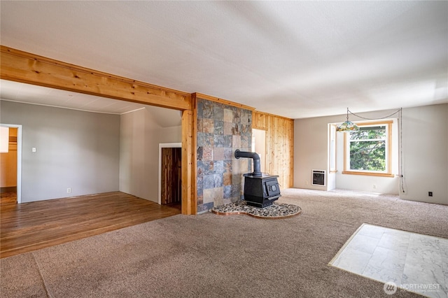595 Division St, Manson, WA 98831 - unfurnished living room with a wood stove, carpet, and heating unit